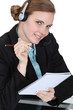call center employee holding a notepad
