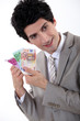 Businessman holding Euro bank notes