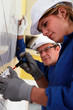 Young woman installing an electrical outlet