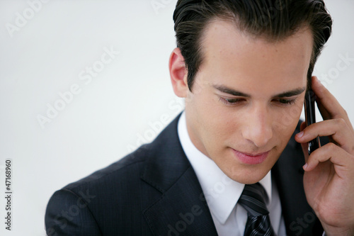 Photo: businessman talking on his cell businessman talking on his cell