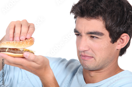 Photo: Man holding cheeseburger Man holding cheeseburger