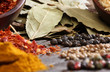 Different spices over a dark wood.