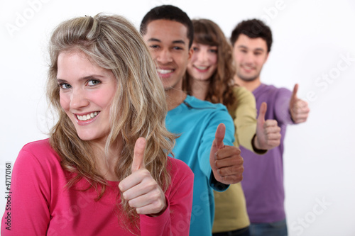 Photo: Young group of people giving the thumb's up Young group of people giving the thumb's up