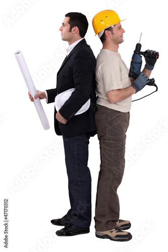 Photo: Tradesman and engineer standing back to back Tradesman and engineer standing back to back