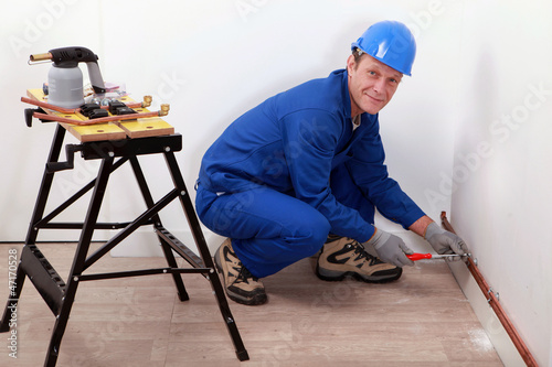 Photo: professional repairman working on a wall professional repairman working on a wall