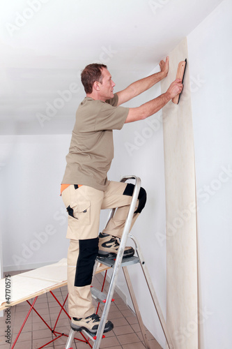 Photo: Handyman laying wallpaper Handyman laying wallpaper