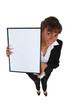 Businesswoman holding up a whiteboard