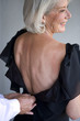 Woman wearing a dress with a low back
