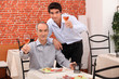 Father and son having dinner together