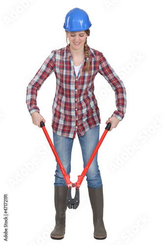 Photo: Woman using bolt-cutters Woman using bolt-cutters