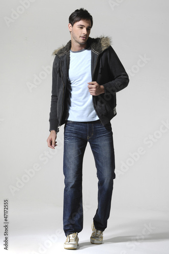 Photo: Full length portrait of a stylish young man standing Full length portrait of a stylish young man standing
