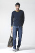 Full length young Casual man with bag posing in the studio