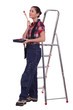 Young woman stood by ladder with paint brush