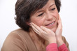 Children's hands stroking grandma's face