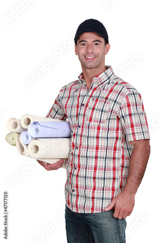 Photo: Man with rolls of wallpaper Man with rolls of wallpaper