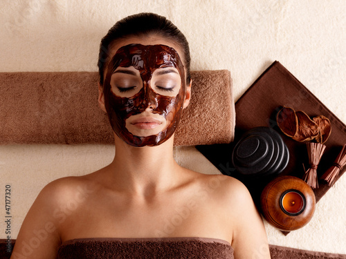 Photo: woman relaxing with facial mask on face at beauty salon woman relaxing with facial mask on face at beauty salon