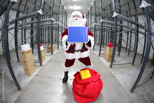 Photo: Santa Claus preparing for Christmas,showing gift Santa Claus preparing for Christmas,showing gift