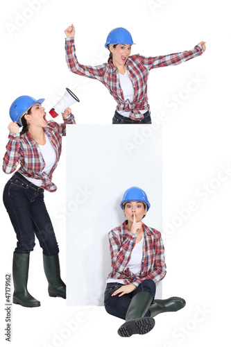 Photo: Triplets dancing around a blank sign Triplets dancing around a blank sign
