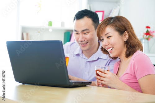 Photo: Asian couple using notebook Asian couple using notebook