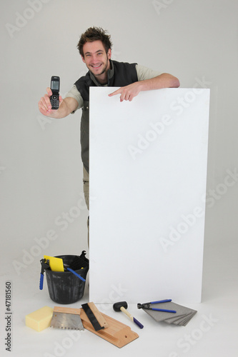Photo: Decorator displaying mobile phone Decorator displaying mobile phone