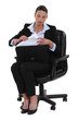 Businesswoman getting documents out of a briefcase