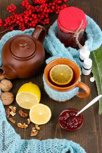 Photo: Helpful tea with jam for immunity on wooden table close-up Helpful tea with jam for immunity on wooden table close-up