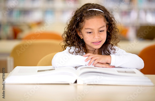 Photo: School girl reading a book School girl reading a book