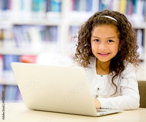 Photo: Girl using a laptop computer Girl using a laptop computer