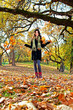 Happy young pretty woman at the autumn  park.