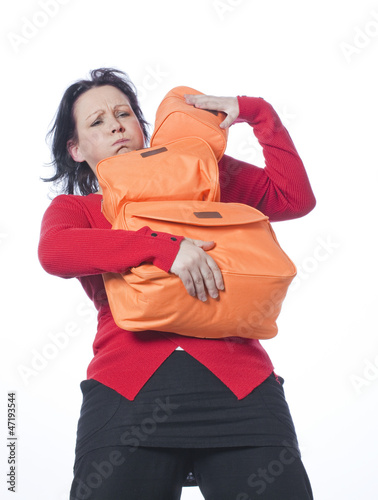 Photo: Female traveler fed up with carrying her luggage Female traveler fed up with carrying her luggage