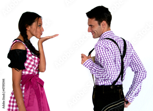 Photo: Fröhliches Bayerisches Paar mit Lederhosen und Dirndl Fröhliches Bayerisches Paar mit Lederhosen und Dirndl