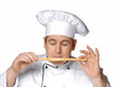 Foto: Un cocinero,chef probando,oliendo pan.palillo de pan. Un cocinero,chef probando,oliendo pan.palillo de pan.