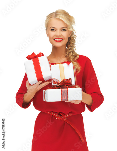 Photo: lovely woman in red dress with gift boxes lovely woman in red dress with gift boxes