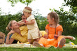 Happy family picnicking outdoors