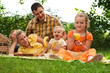 Happy family picnicking outdoors