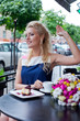 a beautiful young blond girl in summer dress at the table in pav