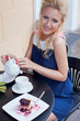 a beautiful young blond girl in summer dress at the table in pav