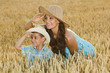 mother and son in a field of wheat