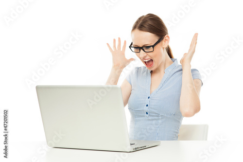Photo: Female shocked at something on her computer Female shocked at something on her computer