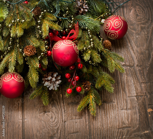 Photo: Christmas Decoration. Holiday Decorations over wooden background Christmas Decoration. Holiday Decorations over wooden background