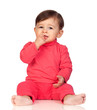 Adorable baby girl with her hand in mouth sitting