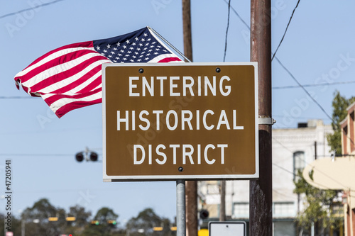 Photo: Entering Historical District Road Sign with American Flag Entering Historical District Road Sign with American Flag
