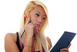 Woman thinking while writing on notepad