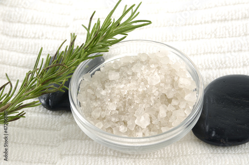 Photo: Bowl of sea salt with leaf and stone on towel Bowl of sea salt with leaf and stone on towel