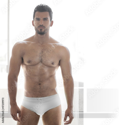 Photo: Sexy young male muscular model in white underwear Sexy young male muscular model in white underwear