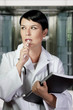 Thinking medical doctor with stethoscope. Over hospital backgrou