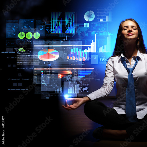 Photo: Business woman with financial symbols around Business woman with financial symbols around