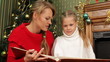 Mother reading a tale to her daughter