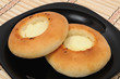 Photo: Two curd tarts on a black plate Two curd tarts on a black plate