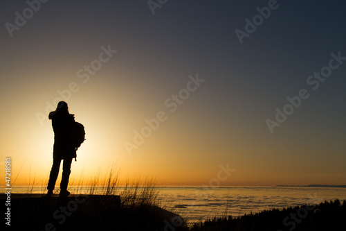 Photo: silhouette of woman standing in sunset silhouette of woman standing in sunset